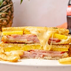 Stacked halves of a pineapple grilled cheese sandwich with melted cheese coming out.