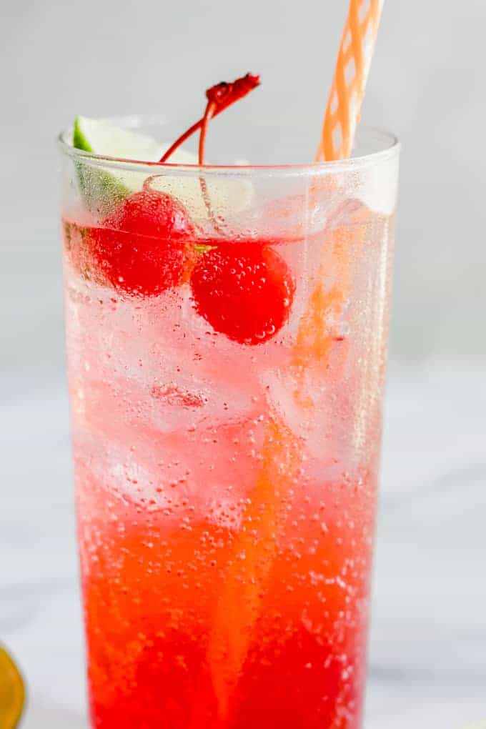 Bubbly and cold Cherry Limeade with a straw. 