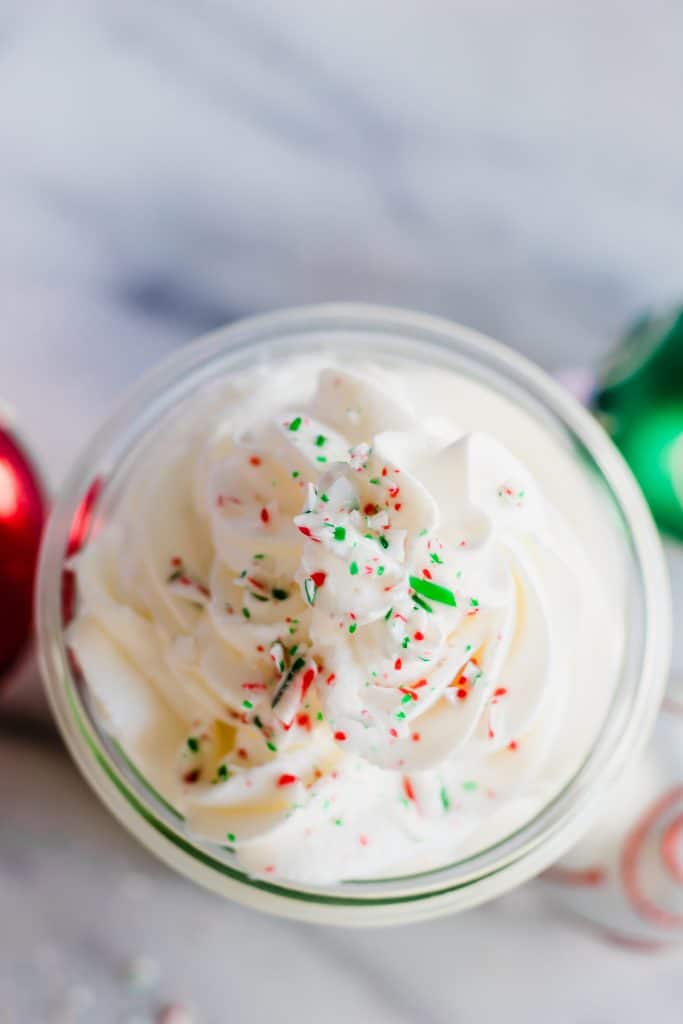 Peppermint Whipped Cream, only three ingredients, super easy, and delightfully minty!  Perfect on top of any hot drink, or just to eat with a spoon.  