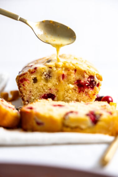 Cranberry orange bread with orange glaze drizzle.