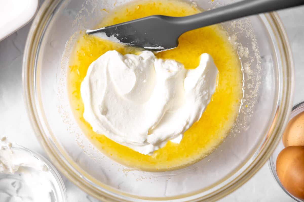 Combining wet ingredients in a mixing bowl.