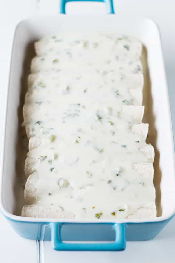Tequila Lime Chicken Enchiladas with a Creamy Jalapeño Cilantro Sauce. These enchiladas are SO flavorful! Full of tender tequila lime chicken, cheese, and topped with a cheesy, creamy jalapeño cilantro sauce. 