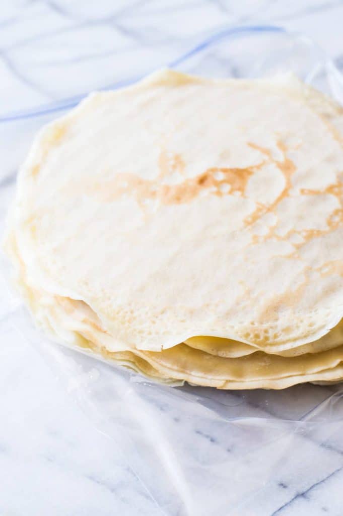 A whipped lemon mascarpone cream filling is layered with lightly sweetened crepes for a perfect dessert or brunch recipe!! Topped with lemon curd whipped cream and fresh berries! 