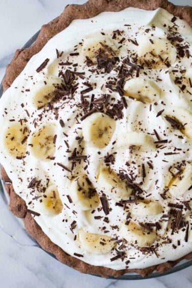Chocolate Banana Cream Pie. Chocolate pie crust loaded up with layers of chocolate cream, bananas, and vanilla cream. All topped with a thick layer of whipped cream!