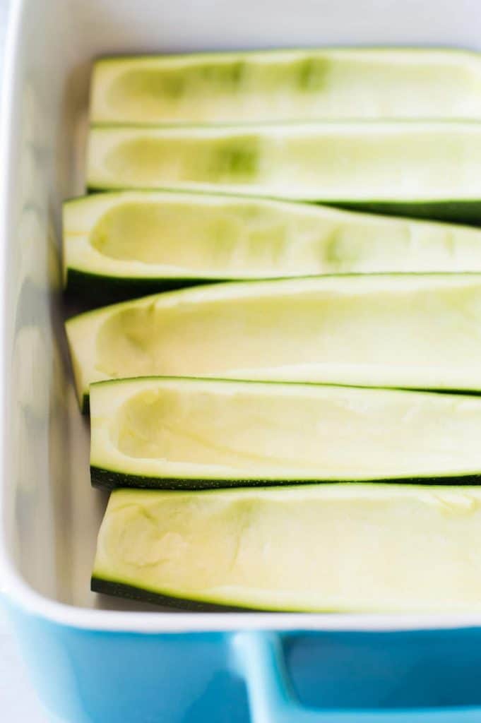 Hollowed out zucchini ready to be made into chicken enchilada zucchini boats.