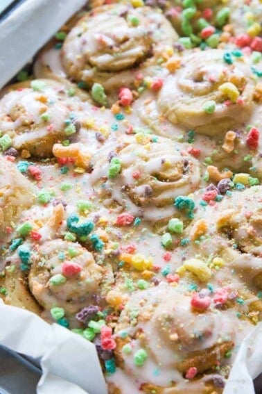 Overnight Fruit Loop Sweet Rolls made with cereal milk! Get a head start on breakfast by prepping these Fruit Loop sweet rolls the night before! Made with actual fruity cereal milk, loaded with pieces of fruit loops, and all drizzled with a fruity cereal milk glaze. These will always win the prize for the most fun breakfast!