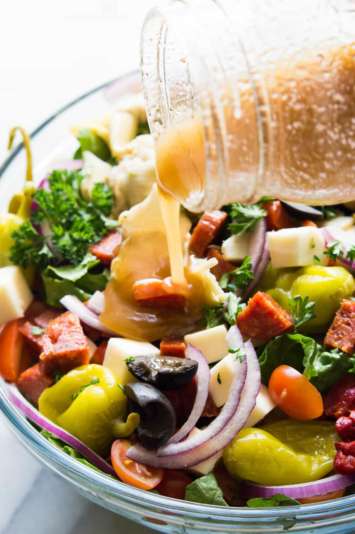 Antipasto Salad! The perfect side dish to go along with your Italian meals, loaded with artichoke hearts, roasted red peppers, olives, pepperoni, and fresh mozzarella! Not to mention drizzled with an easy to make vinaigrette made with pantry items! 