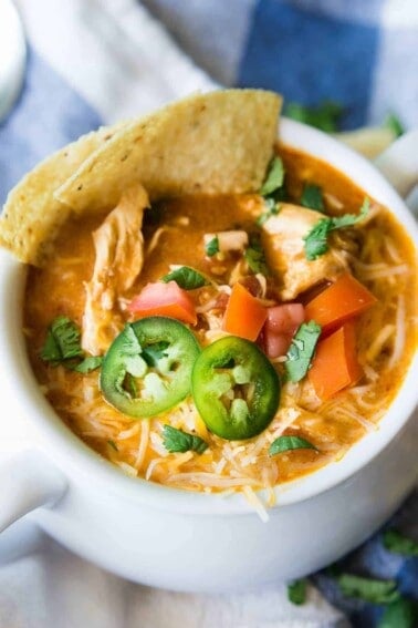 Slow Cooker King Ranch Chicken Soup. This EASY soup tastes just like the beloved King Ranch Chicken Casserole. Loaded with cheese, juicy chunks of chicken, and tons of flavor! Simply load up the slow cooker and let this soup simmer during the day so you can enjoy this for dinner!