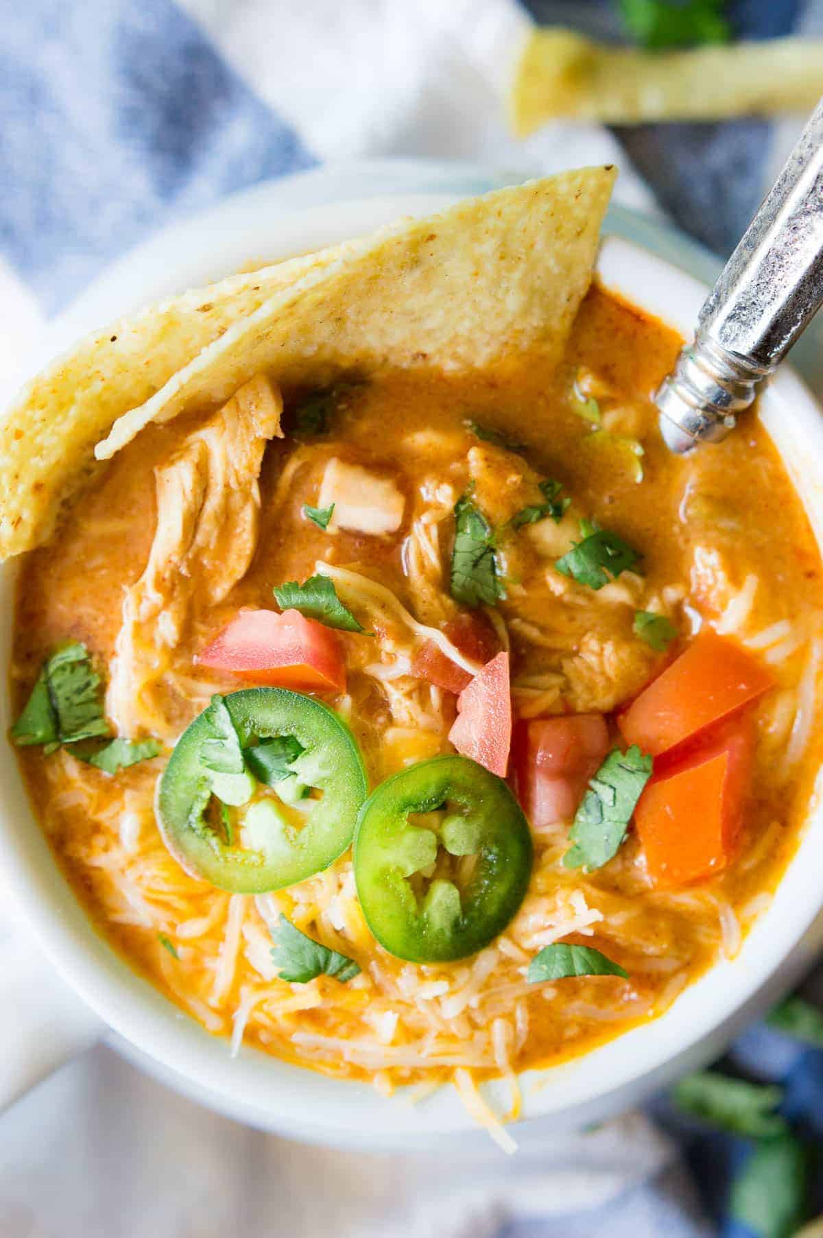 Slow Cooker King Ranch Chicken Soup. This EASY soup tastes just like the beloved King Ranch Chicken Casserole. Loaded with cheese, juicy chunks of chicken, and tons of flavor! Simply load up the slow cooker and let this soup simmer during the day so you can enjoy this for dinner!