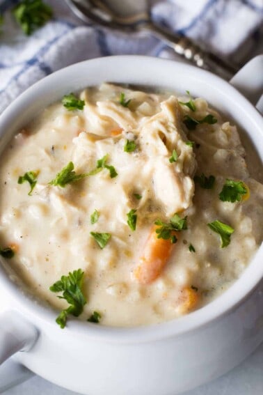 Slow Cooker Creamy Chicken and Wild Rice Soup! This soup is ultra creamy, ultra flavorful, and best part? There's no actual cream or butter used! This is the perfect lighter version of a classic comfort food.