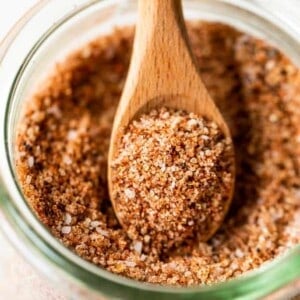 Wooden spoon scooping up homemade texas style dry rub.