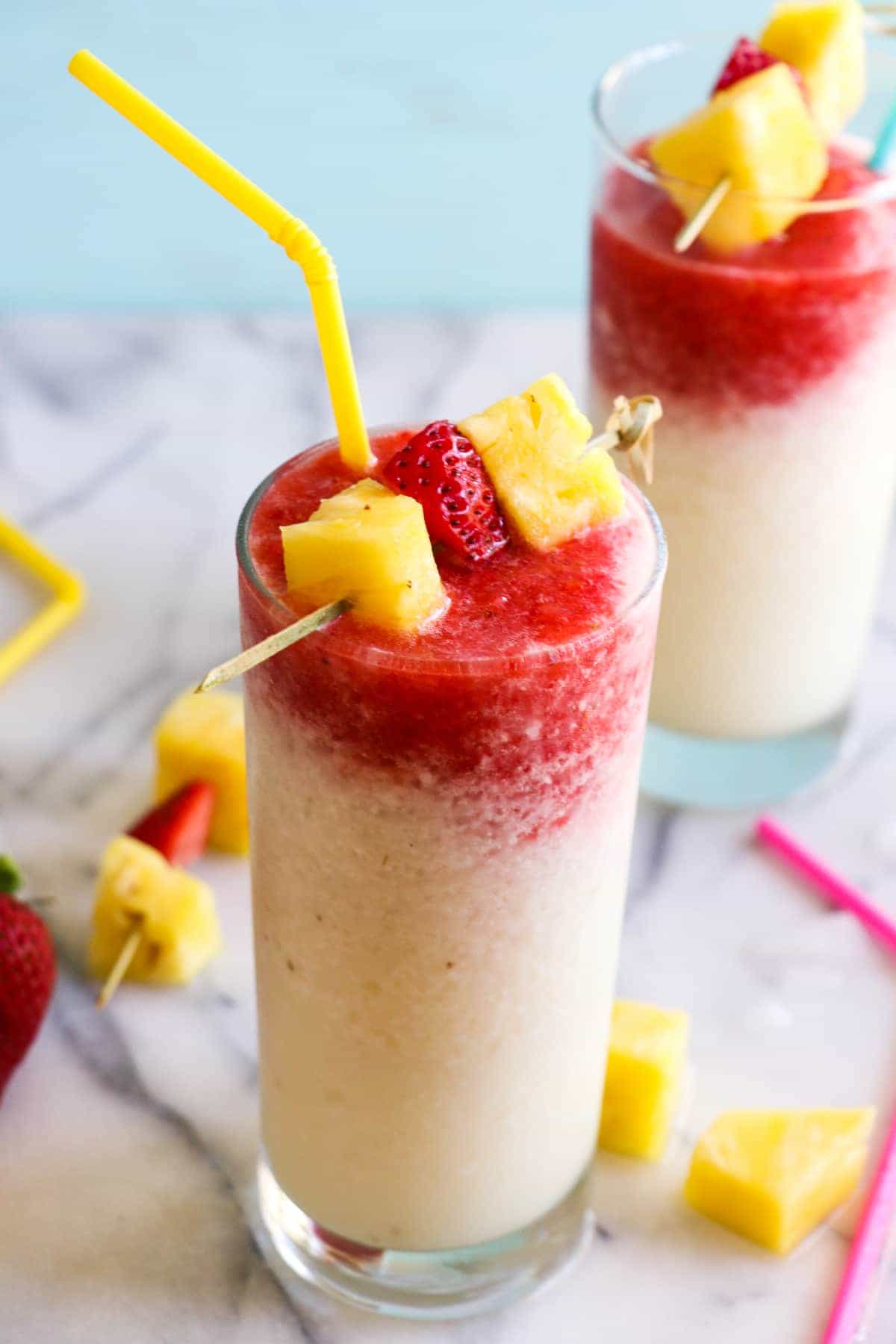Virgin Lava Flow Slush! Enjoy the tropical flavors of pineapple, coconut and banana swirled with strawberry in this frosty and slushy drink! Feel free to add a little rum if desired! The perfect summertime drink!