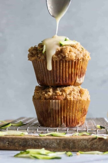 Zucchini Crumb Muffins with Lemon Cream Cheese Glaze.  These muffins are loaded up with fresh zucchini, spiced up with a hint of cinnamon, and made lighter by using greek yogurt!  Not to mention the sweet hint of crumb topping baked right into the muffin.  Top it all off with a drizzle of lemon cream cheese glaze. 