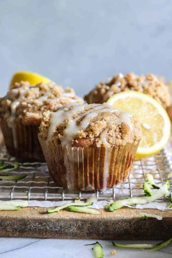 Zucchini Crumb Muffins with Lemon Cream Cheese Glaze.  These muffins are loaded up with fresh zucchini, spiced up with a hint of cinnamon, and made lighter by using greek yogurt!  Not to mention the sweet hint of crumb topping baked right into the muffin.  Top it all off with a drizzle of lemon cream cheese glaze. 