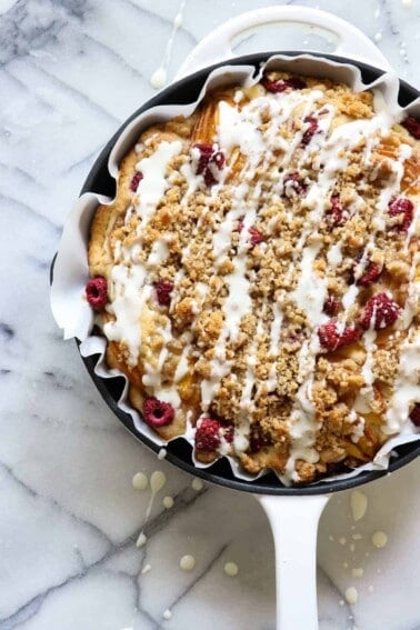 Peach Raspberry Crumb Cake!  A moist cake topped with fresh juicy peaches and sweet raspberries.  All covered in a sweet brown sugar crumb. 