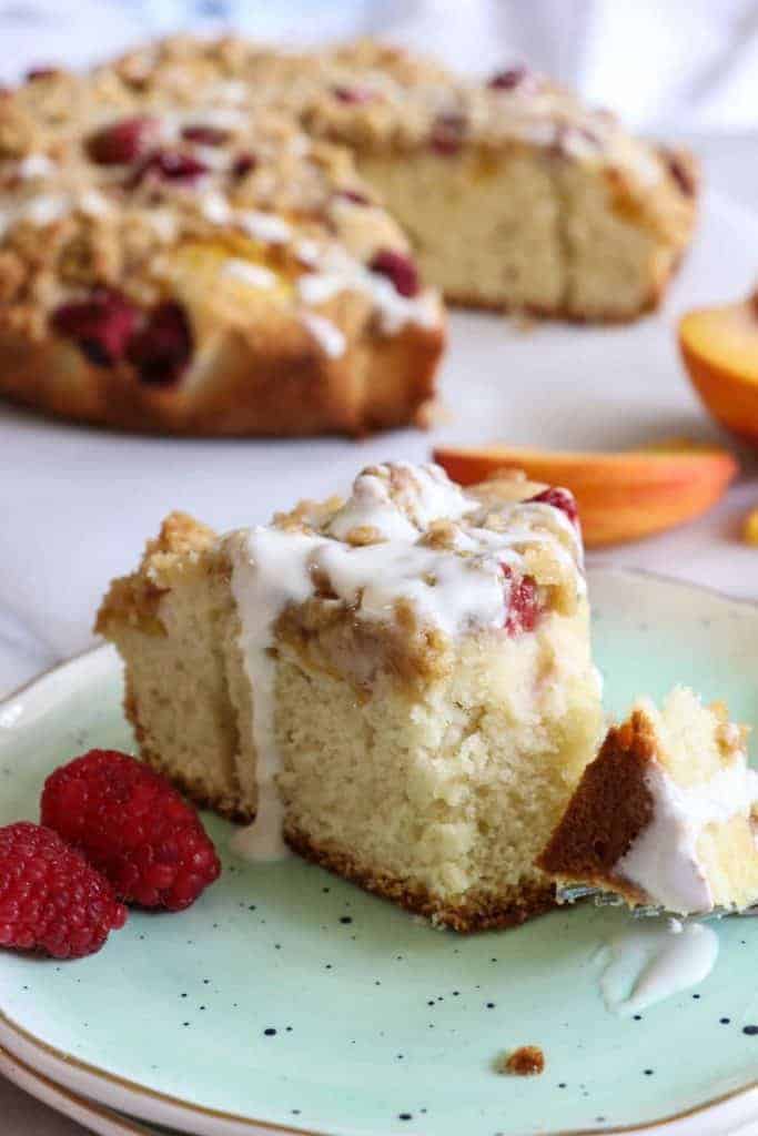 Peach Raspberry Crumb Cake!  A moist cake topped with fresh juicy peaches and sweet raspberries.  All covered in a sweet brown sugar crumb. 