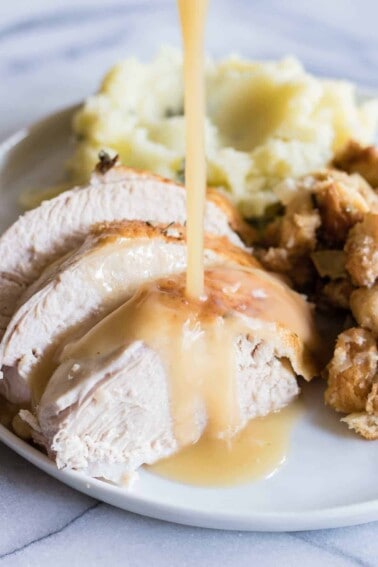 Tender and juicy turkey perfect for Thanksgiving day. Plus instructions on how to make turkey stock, gravy and stuffing too! 