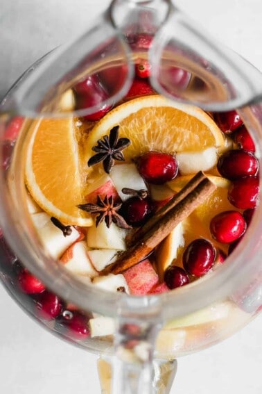 Sparkling Apple Cider Sangria. Sparkling Apple cider loaded up with chunks of apple, orange, cranberries, and all the best fall spices. No alcohol included makes this perfect for the entire family!