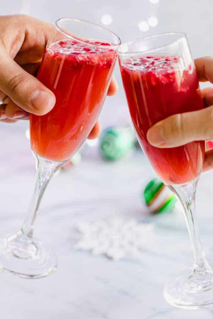 Christmas Mimosas! Celebrate Christmas in the morning with this mimosa that has a combination of orange juice and pomegranate juice! 