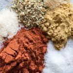 Measured out spices prepared to mix for homemade taco seasoning.