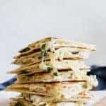 Stack of cheesy spinach and artichoke chicken quesadillas.
