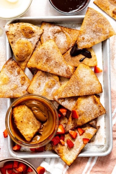 Baking tray with Cinnamon Tortilla Chips served with dulce de leche and fudge sauce.