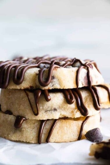 Stack of Chocolate Chip Shortbread cookies drizzled with extra chocolate.