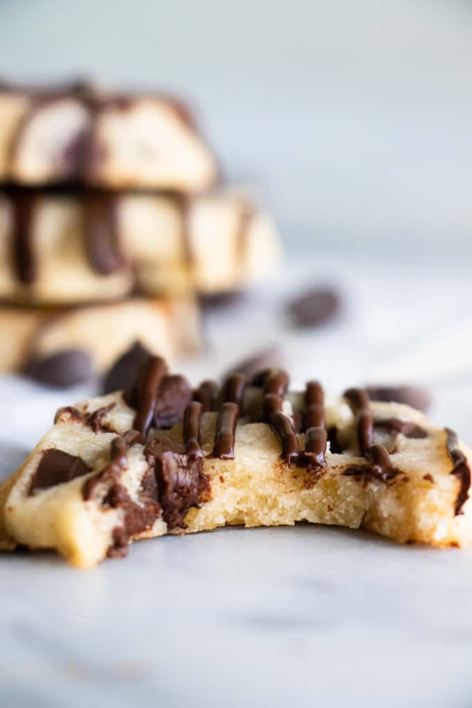 A bitten into chocolate chip shortbread cookie.