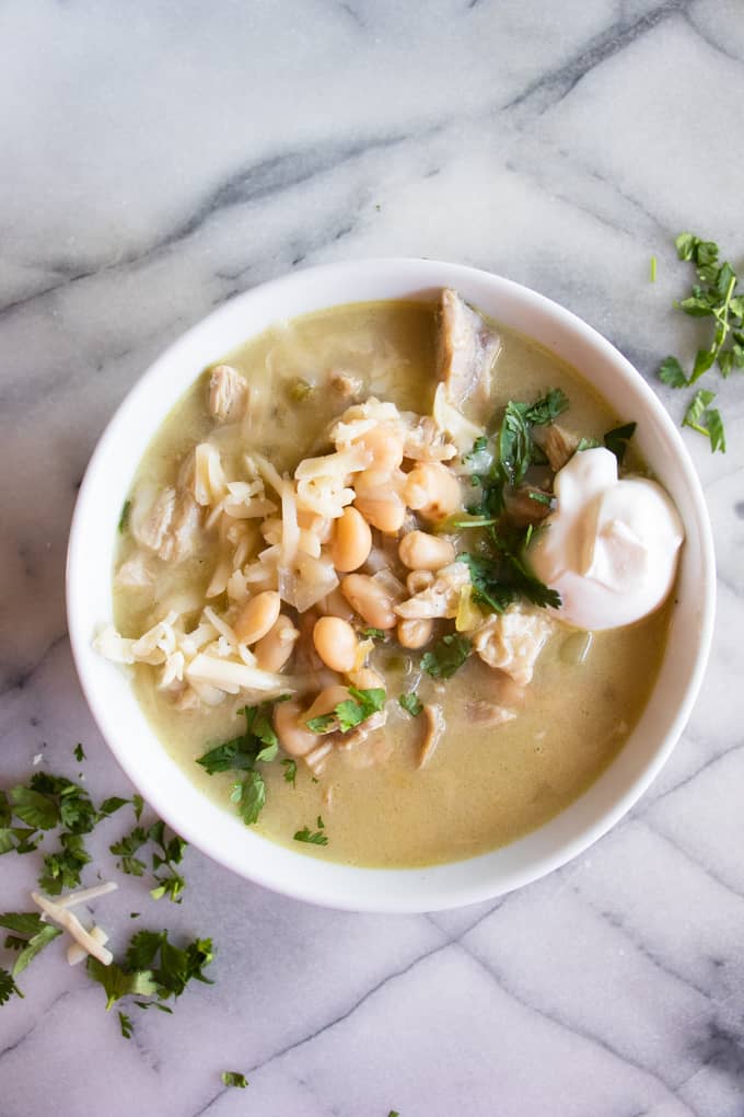 Bowl filled with green Chile chicken enchilada soup. 