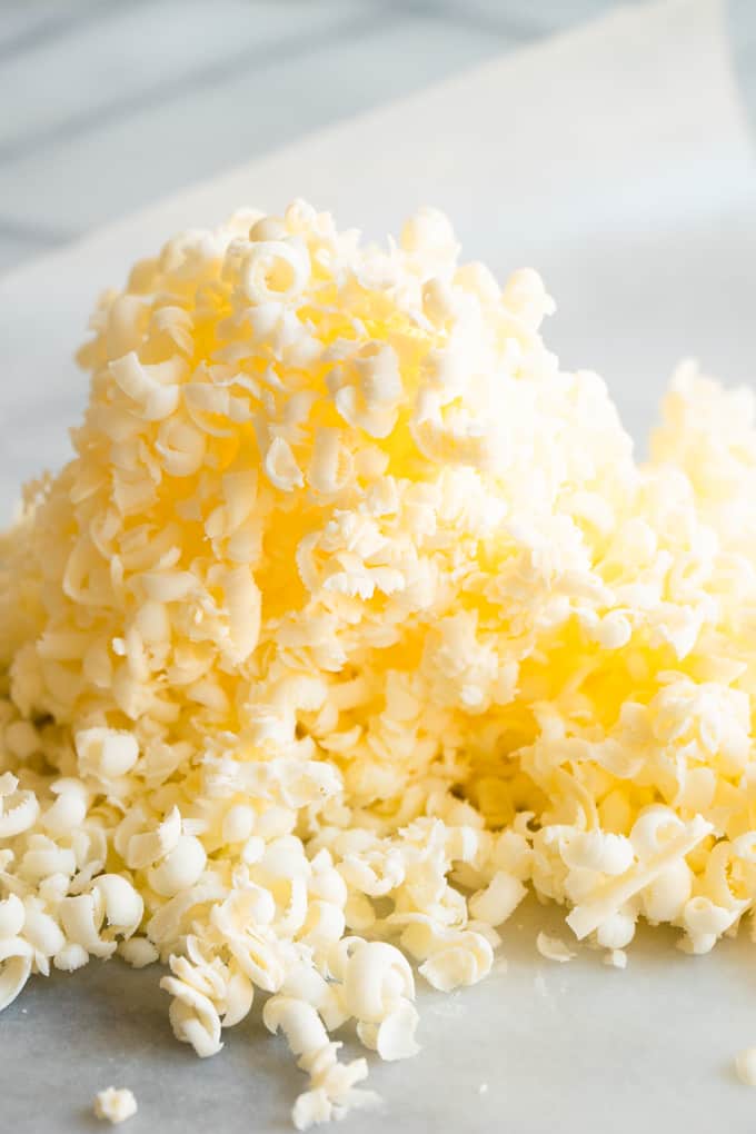 A pile of grated cold butter for making homemade biscuits.