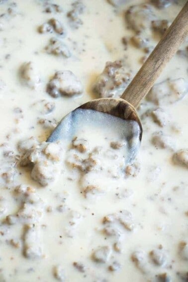 Spoon dipping into homemade sausage gravy.