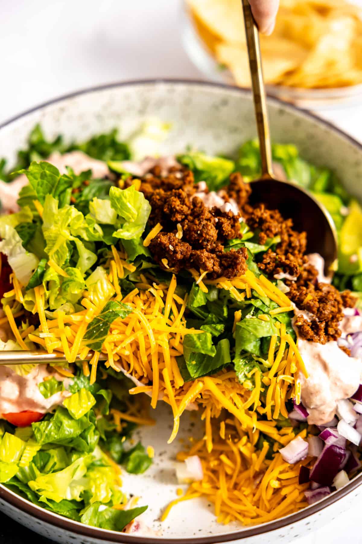 Tossing a taco salad.