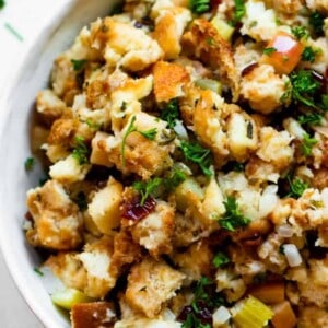 Close up of cranberry apple stuffing garnished with fresh parsley.