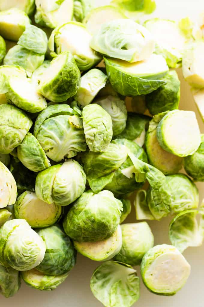 Cleaned up Brussels sprouts, bottoms cut off, loose leaves removed and cut in half.