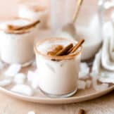Glass rimmed with cinnamon and filled with cold and creamy homemade horchata, served with cinnamon sticks.