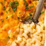 Spoon serving up homemade baked macaroni and cheese.