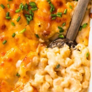 Spoon serving up homemade baked macaroni and cheese.