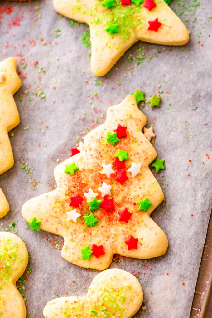 Sugar cookie with Christmas sprinkles on a baking sheet.