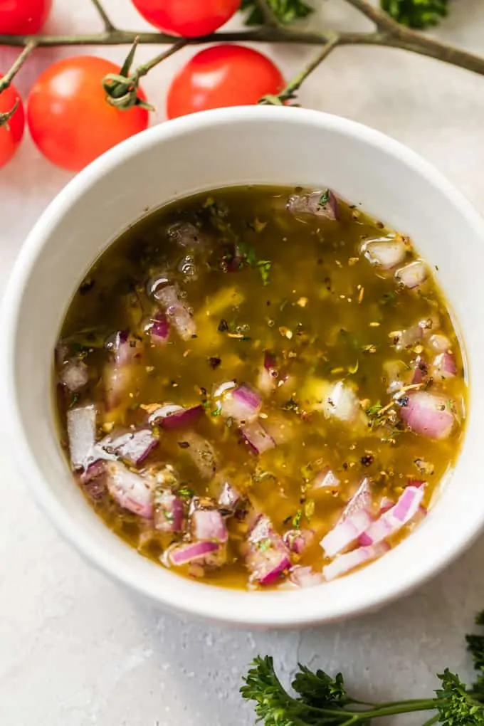 Red onion soaking in Italian dressing before using in a salad.