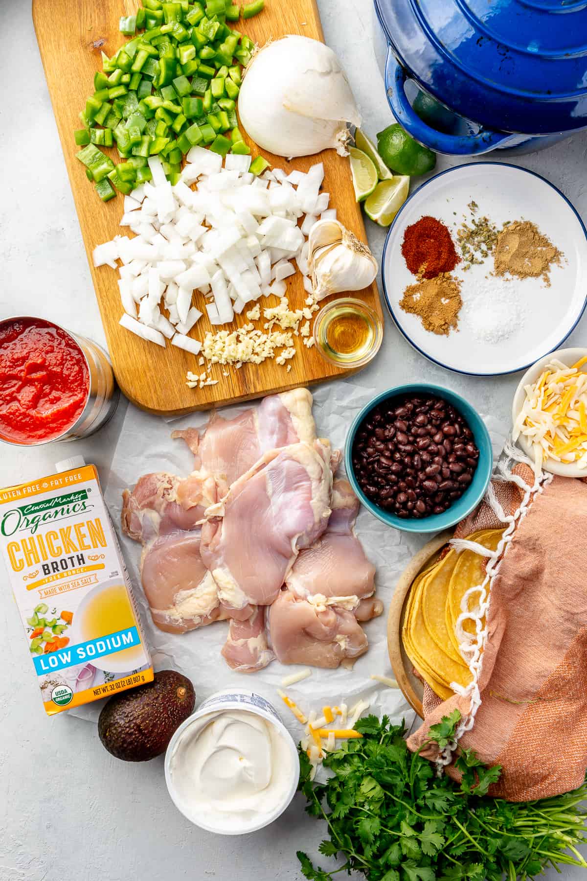 Ingredients needed to make chicken tortilla soup laid out on the counter. 