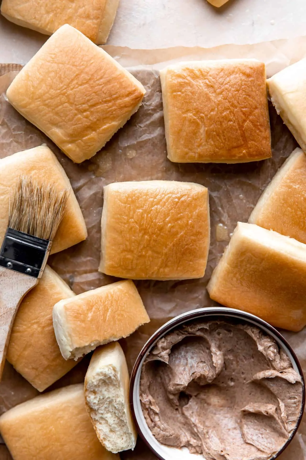 Baked Texas Roadhouse Rolls with a bowl of cinnamon honey butter.