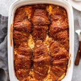 Baking dish with ham and cheese croissant breakfast casserole.