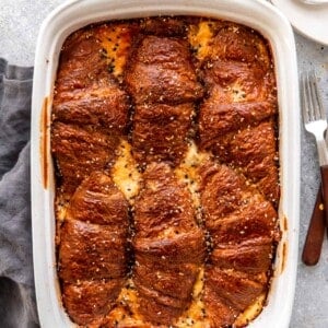 Baking dish with ham and cheese croissant breakfast casserole.