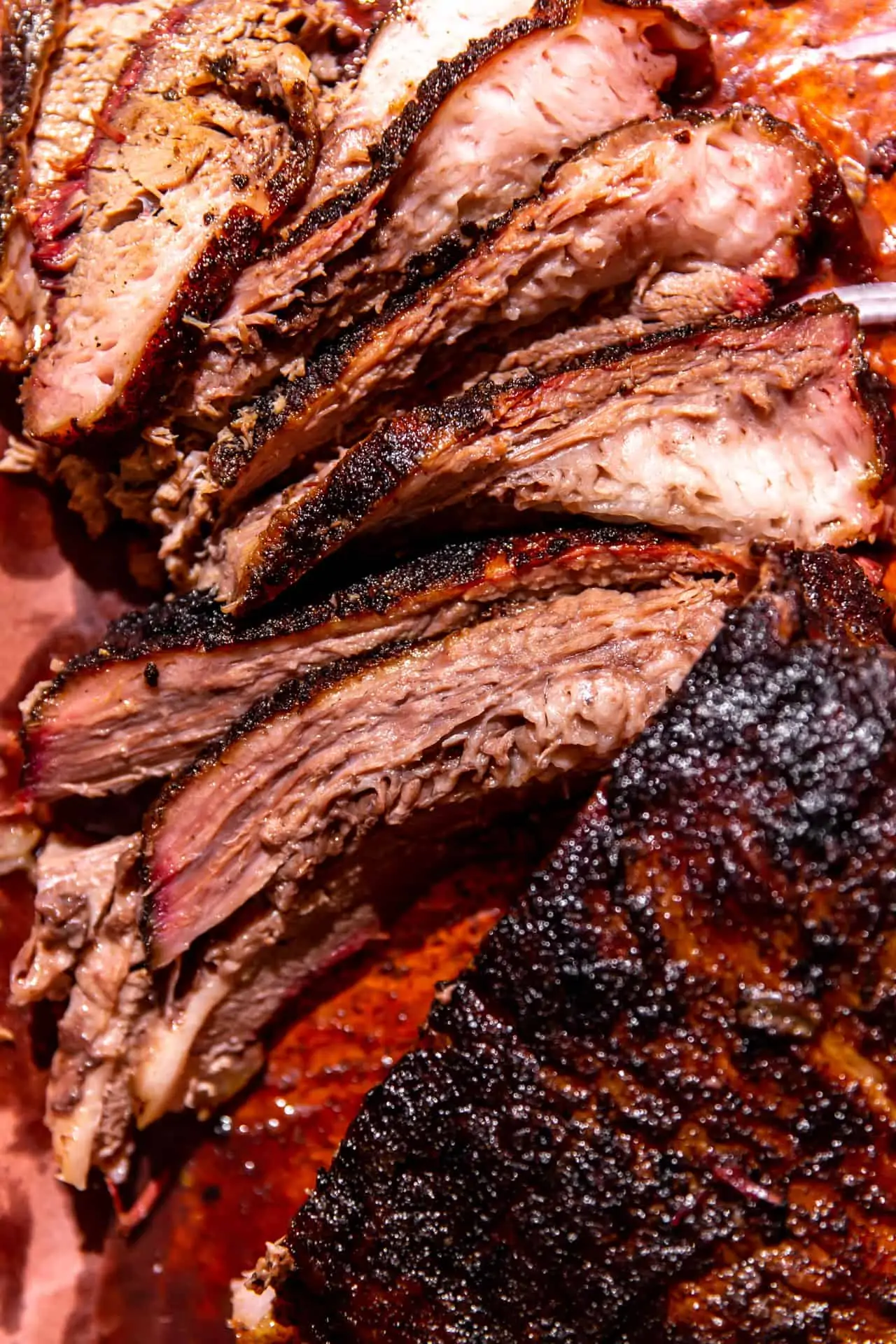 Sliced Texas Smoked Brisket on peach paper.