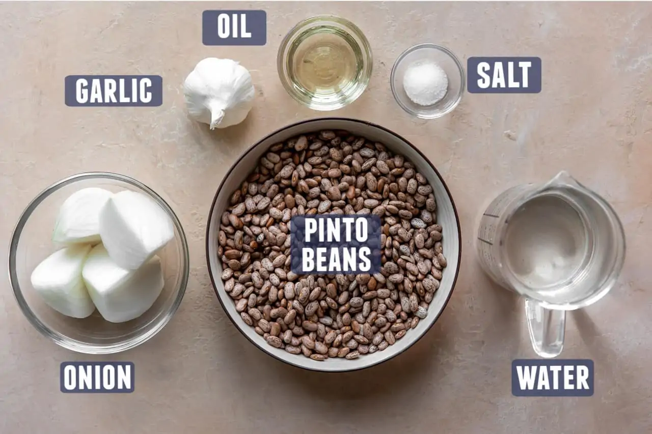Ingredients needed to make homemade refried beans laid out on the counter.
