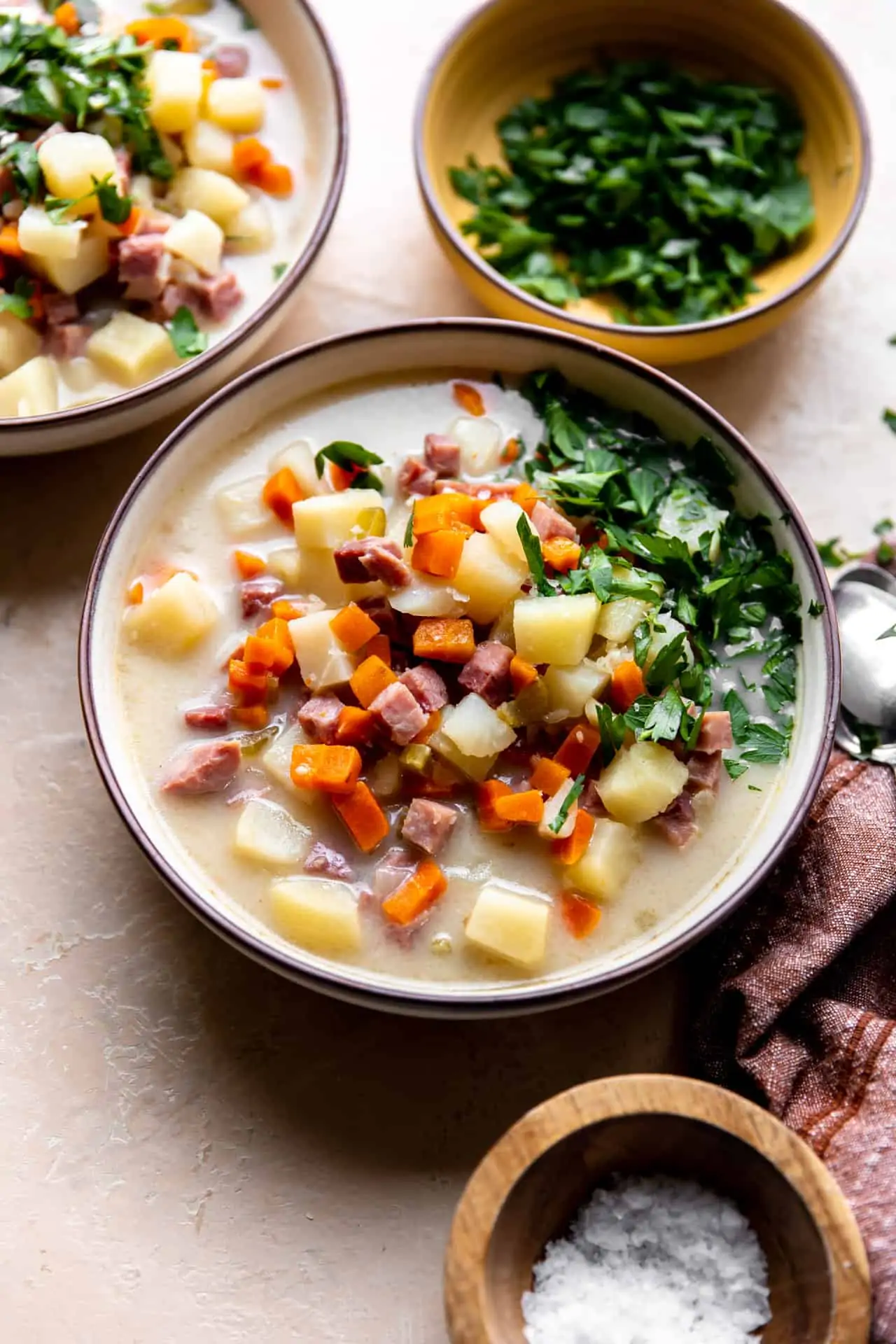Bowl of ham bone soup served with fresh parsley on top. 