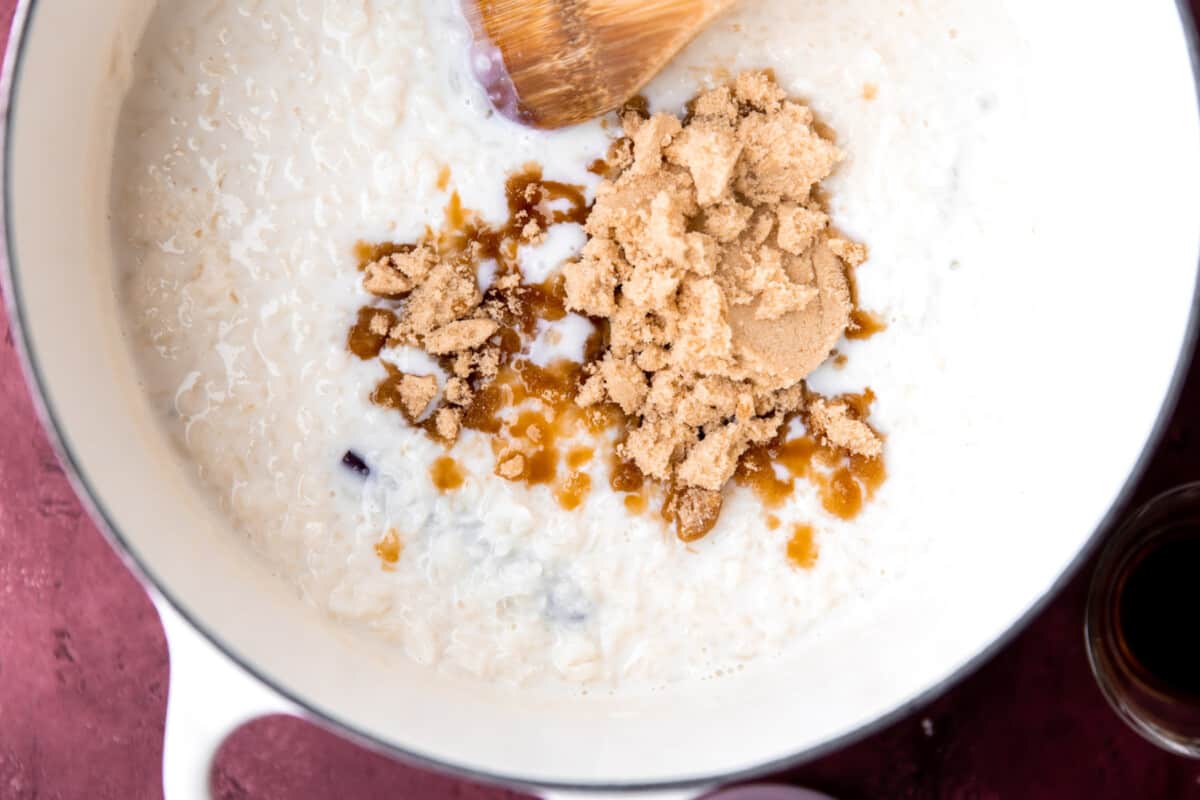 Brown sugar and vanilla being stirred into rice pudding.