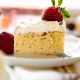 Homemade tres leches, three milk cake, topped with fresh strawberries.