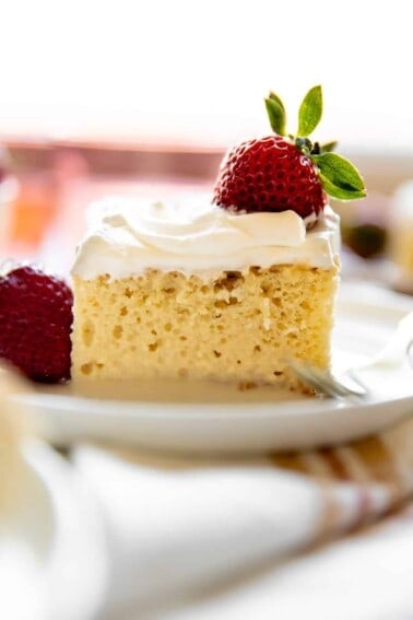 Homemade tres leches, three milk cake, topped with fresh strawberries.