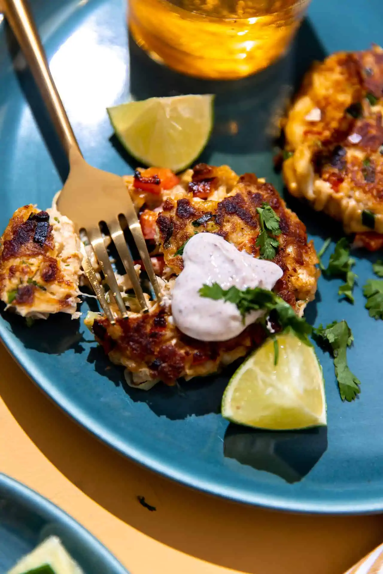 Up close view of crab cake being served with a fork. 